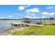 Waterfront property boasts a spacious dock with gazebo, perfect for lake access and enjoying waterfront views at 900 Lake Jessie Dr, Winter Haven, FL 33881