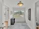 Bright foyer featuring a large window, tiled floor, and neutral decor at 900 Lake Jessie Dr, Winter Haven, FL 33881