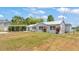 Exterior home with metal roof, carport, and well-kept front lawn enhances the overall curb appeal at 900 Lake Jessie Dr, Winter Haven, FL 33881