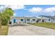 Charming home with metal roof, carport, and inviting front yard, enhancing its curb appeal at 900 Lake Jessie Dr, Winter Haven, FL 33881