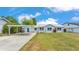 Well-maintained home with a carport, set on a manicured lawn for a welcoming curb appeal at 900 Lake Jessie Dr, Winter Haven, FL 33881