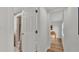 Hallway showing a bathroom with a tiled shower and a doorway to a room at 900 Lake Jessie Dr, Winter Haven, FL 33881