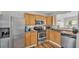 Well-lit kitchen with stainless steel appliances, wood cabinets, and a double-door refrigerator at 900 Lake Jessie Dr, Winter Haven, FL 33881