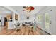 Open living room area with hardwood floors, a ceiling fan, and natural light from a window at 900 Lake Jessie Dr, Winter Haven, FL 33881