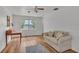 Cozy living room area with hardwood floors, natural light, and simple decor at 900 Lake Jessie Dr, Winter Haven, FL 33881
