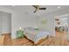 Comfortable main bedroom with stylish lamps and wood-look floors at 900 Lake Jessie Dr, Winter Haven, FL 33881