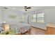 Light-filled main bedroom with a ceiling fan and relaxing views of the water at 900 Lake Jessie Dr, Winter Haven, FL 33881