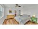 Comfortable main bedroom with a wooden dresser and colorful decor at 900 Lake Jessie Dr, Winter Haven, FL 33881