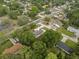 Overhead shot of the home featuring lush tree coverage and a neatly maintained lawn in a quiet neighborhood at 1003 Bear Lake Rd, Apopka, FL 32703