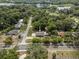 Aerial view of a home nestled among mature trees, showcasing its location near a lake at 1003 Bear Lake Rd, Apopka, FL 32703