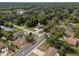 An aerial view shows the property nestled among mature trees near a road and other residential homes at 1003 Bear Lake Rd, Apopka, FL 32703