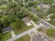 Aerial view of a single-story home with a grey roof, mature trees, and a long driveway in a residential area at 1003 Bear Lake Rd, Apopka, FL 32703