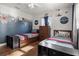 Bright bedroom featuring two beds, hardwood flooring, and airplane decor at 1003 Bear Lake Rd, Apopka, FL 32703