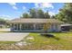 Inviting single-story home featuring a covered porch, landscaped yard, and neutral color palette at 1003 Bear Lake Rd, Apopka, FL 32703