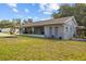 Attractive single-story home with a covered porch, complemented by lush green lawn at 1003 Bear Lake Rd, Apopka, FL 32703
