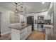 Modern kitchen boasting stainless steel appliances and an island with seating at 1003 Bear Lake Rd, Apopka, FL 32703