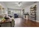 Comfortable living room with hardwood floors, sofa, and shelving at 1003 Bear Lake Rd, Apopka, FL 32703