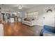 Open-concept living room showcasing hardwood floors and seamless transition into the modern kitchen at 1003 Bear Lake Rd, Apopka, FL 32703