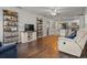 Open-concept living room with hardwood floors, neutral furniture, and seamless flow into the kitchen at 1003 Bear Lake Rd, Apopka, FL 32703