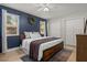 Main bedroom with dark blue accent wall and double closets at 1003 Bear Lake Rd, Apopka, FL 32703