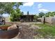 Rustic backyard area featuring dog kennels, trees, and partially fenced perimeter at 105 Leslie Ave, Winter Haven, FL 33880