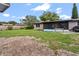 Large backyard with a screened in lanai and green grass at 105 Leslie Ave, Winter Haven, FL 33880