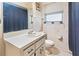 Cozy bathroom with single sink vanity, floral wallpaper, and shower with curtain at 105 Leslie Ave, Winter Haven, FL 33880