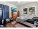 Bedroom features an updated floor, dresser, and a bright window at 105 Leslie Ave, Winter Haven, FL 33880
