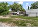Gated front yard featuring a work truck with a trailer, and mature landscaping at 105 Leslie Ave, Winter Haven, FL 33880