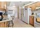 Functional kitchen with neutral countertops and updated appliances offering a practical cooking space at 105 Leslie Ave, Winter Haven, FL 33880