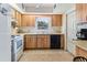 Bright kitchen featuring wood cabinets, tiled flooring, and modern appliances at 105 Leslie Ave, Winter Haven, FL 33880
