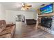 Open-concept living room with hardwood floors, a fireplace, and an arched doorway at 105 Leslie Ave, Winter Haven, FL 33880