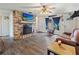 Inviting living room featuring a brick fireplace, hardwood flooring, and ample natural light at 105 Leslie Ave, Winter Haven, FL 33880