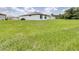 Wide shot of a well-maintained backyard showcasing the expansive lawn space at 1050 Michelangelo Ln, Winter Haven, FL 33884