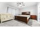 Bedroom with grey carpet, nice bed, and crib, offering a cozy and comfortable space at 1050 Michelangelo Ln, Winter Haven, FL 33884