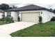 This property has a two car garage and well-kept landscaping at 1050 Michelangelo Ln, Winter Haven, FL 33884