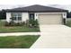 Charming one-story home with well-maintained lawn and tidy landscaping at 1050 Michelangelo Ln, Winter Haven, FL 33884