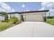 Charming one-story home featuring an attached two car garage and freshly landscaped yard at 1050 Michelangelo Ln, Winter Haven, FL 33884