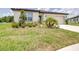 Well-maintained lawn and landscaped front yard adds curb appeal to this cozy home at 1050 Michelangelo Ln, Winter Haven, FL 33884