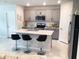 Modern kitchen with a stylish island, stainless steel appliances, and sleek countertops at 1050 Michelangelo Ln, Winter Haven, FL 33884