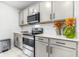 The kitchen has modern stainless steel appliances, lots of counter space and tile flooring at 1050 Michelangelo Ln, Winter Haven, FL 33884