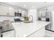 Modern kitchen features gray cabinets, stainless appliances, and a center island at 1050 Michelangelo Ln, Winter Haven, FL 33884