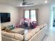 Comfortable living room area with neutral colors, natural light, and ceiling fan at 1050 Michelangelo Ln, Winter Haven, FL 33884