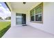 A patio with white walls and a sliding glass door at 1050 Michelangelo Ln, Winter Haven, FL 33884