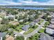 Panoramic aerial view of a neighborhood with mature trees and a blue lake visible in the distance at 109 Lake Mariam Way, Winter Haven, FL 33884