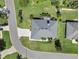 Aerial shot of a home with a paver driveway, mature landscaping and a screen enclosed lanai at 109 Lake Mariam Way, Winter Haven, FL 33884