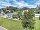 Overhead view of a meticulously landscaped home with a large, green lawn and mature trees at 109 Lake Mariam Way, Winter Haven, FL 33884