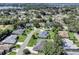 Wide aerial view highlighting the home in the suburban Lake Marian Hills neighborhood with mature trees at 109 Lake Mariam Way, Winter Haven, FL 33884