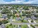 An aerial shot showcasing the property in a neighborhood with mature trees and residential streets near a lake at 109 Lake Mariam Way, Winter Haven, FL 33884