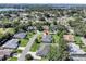 Aerial shot showcasing the home's location within the Lake Marian Hills community, surrounded by lush greenery and a lake at 109 Lake Mariam Way, Winter Haven, FL 33884